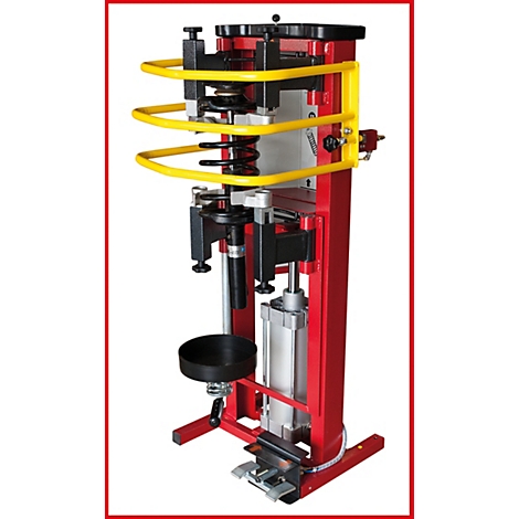 Rote Federgabelpresse mit gelbem Schutzbügel. Details: schwarze Halterung, zylindrisches Gehäuse.